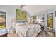 Spacious bedroom with king-size bed and wood-look floors at 4419 Glebe Farm Rd # 149, Sarasota, FL 34235