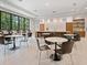 Bright and airy community room with tables and chairs at 4419 Glebe Farm Rd # 149, Sarasota, FL 34235