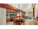 Dining area with wooden table and chairs, adjacent to the kitchen and living room at 4419 Glebe Farm Rd # 149, Sarasota, FL 34235