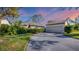 Attractive exterior featuring a two-car garage and lush landscaping at 4419 Glebe Farm Rd # 149, Sarasota, FL 34235