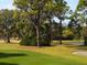 Golf course with lush green fairways, sand traps, and mature trees at 4419 Glebe Farm Rd # 149, Sarasota, FL 34235
