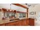 Spacious kitchen with granite countertops, wood cabinets, and view of dining area at 4419 Glebe Farm Rd # 149, Sarasota, FL 34235