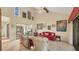 Bright living room with high ceilings, hardwood floors, and access to a private courtyard at 4419 Glebe Farm Rd # 149, Sarasota, FL 34235