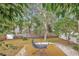 Peaceful backyard with a deck, trees, and a relaxing seating area at 4530 Murdock Ave, Sarasota, FL 34231