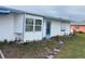 White single story home with blue trim and small garden at 4744 Argonaut Rd, Venice, FL 34293