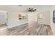 Spacious living room with wood-look floors and ceiling fan at 4963 San Jose Dr, Sarasota, FL 34235