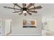 Living room with a view into the kitchen and a large ceiling fan at 4963 San Jose Dr, Sarasota, FL 34235