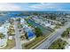 Elevated view of a canal-front community with damaged properties and blue tarps on roofs at 501 65Th St, Holmes Beach, FL 34217