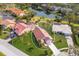 Aerial view of single-Gathering home with red tile roof and landscaped yard at 5512 Gardens Dr, Sarasota, FL 34243