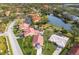 Aerial view of single-Gathering home with red tile roof and landscaped yard at 5512 Gardens Dr, Sarasota, FL 34243