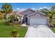 Single-Gathering home with two-car garage and palm trees at 5512 Gardens Dr, Sarasota, FL 34243