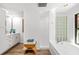 Bathroom with double vanity, a glass block shower, and a soaking tub at 5706 Bent Oak Dr, Sarasota, FL 34232