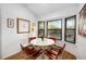 Bright breakfast nook with a round table and leather chairs at 5706 Bent Oak Dr, Sarasota, FL 34232