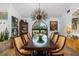 Elegant dining room with a large table, statement chandelier, and art at 5706 Bent Oak Dr, Sarasota, FL 34232