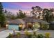 Attractive single-story home with a light-blue garage door and landscaping at 5706 Bent Oak Dr, Sarasota, FL 34232