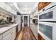 White kitchen cabinets, stainless steel appliances, and hardwood floors at 5706 Bent Oak Dr, Sarasota, FL 34232