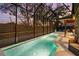 A screened-in pool area at twilight with a pool, patio seating, and enclosed outdoor space at 5706 Bent Oak Dr, Sarasota, FL 34232