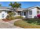 Light blue house with a gray roof, walkway, and nicely landscaped lawn at 6110 Approach Ln, Sarasota, FL 34238