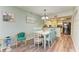 Dining area with light-colored wood table and chairs, and view of the kitchen at 6336 7Th W Ave, Bradenton, FL 34209