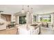 Open concept kitchen and dining with sliding doors to lanai at 6949 Prairie Oak Way, Nokomis, FL 34275