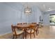 Charming dining area with a wood table and neutral colored chairs at 7134 Westhill Ct, Lakewood Ranch, FL 34202