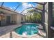 Sparkling pool featuring screened enclosure, brick pavers and lush tropical landscaping at 7134 Westhill Ct, Lakewood Ranch, FL 34202