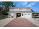 Detached two-story garage or workshop with a paved driveway and white garage door at 7945 Palmer Blvd, Sarasota, FL 34240