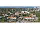 An aerial view of the condominium complex with lush landscaping and nearby waterway at 850 S Tamiami Trl # 227, Sarasota, FL 34236