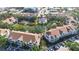 Bird's-eye view of a condo community featuring a pool, tennis court, and pond at 850 S Tamiami Trl # 227, Sarasota, FL 34236