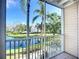 Screened balcony overlooks a tranquil lake and lush greenery, blending indoor-outdoor living at 850 S Tamiami Trl # 227, Sarasota, FL 34236