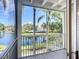 Screened balcony overlooks a tranquil lake and lush greenery, blending indoor-outdoor living at 850 S Tamiami Trl # 227, Sarasota, FL 34236