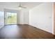 Bright bedroom with wood floors and sliding door to balcony with scenic views at 850 S Tamiami Trl # 227, Sarasota, FL 34236