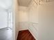 Walk-in closet with built-in wire shelving and wood floor at 850 S Tamiami Trl # 227, Sarasota, FL 34236