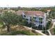 Beautiful multi-story condo building with well-maintained landscaping and mature trees at 850 S Tamiami Trl # 227, Sarasota, FL 34236