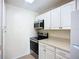 Well-lit kitchen with modern stainless steel appliances and ample cabinet space at 850 S Tamiami Trl # 227, Sarasota, FL 34236