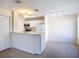 Open-concept layout connecting the kitchen with counter seating to the living and dining area at 850 S Tamiami Trl # 227, Sarasota, FL 34236