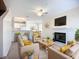 Bright living room with fireplace, ceiling fan, and comfortable seating at 850 S Tamiami Trl # 227, Sarasota, FL 34236