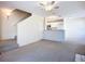 Open-concept living area with carpet and view to kitchen with white cabinets at 850 S Tamiami Trl # 227, Sarasota, FL 34236