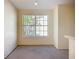Bright living area with window and neutral carpeting at 850 S Tamiami Trl # 227, Sarasota, FL 34236