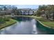 Scenic view of a community pond with a fountain and residential buildings in the background at 850 S Tamiami Trl # 227, Sarasota, FL 34236