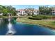 Condo complex with beautiful pond view featuring a fountain and landscaped grounds at 850 S Tamiami Trl # 227, Sarasota, FL 34236