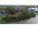 Waterfront condo complex featuring private docks with seating and lush landscaping at 850 S Tamiami Trl # 227, Sarasota, FL 34236