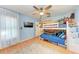 Charming bedroom features custom murals, wood floors, a ceiling fan, and bunk beds at 9363 Steubenville Ave, Englewood, FL 34224