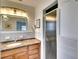 Bright bathroom with granite countertop, wood cabinets, and tiled shower at 9820 Royal Palm Dr, Bradenton, FL 34210