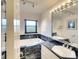 Bathroom with marble vanity, soaking tub, and large mirror at 9820 Royal Palm Dr, Bradenton, FL 34210