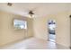 Bedroom with ceiling fan and access to another room at 9820 Royal Palm Dr, Bradenton, FL 34210