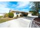 Single-story home with light-beige exterior, driveway and landscaping at 9820 Royal Palm Dr, Bradenton, FL 34210