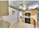 View of kitchen with granite countertops, wood cabinets, and an adjoining bathroom at 9820 Royal Palm Dr, Bradenton, FL 34210