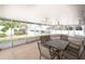 Screened-in porch with ceiling fans and outdoor dining set at 9820 Royal Palm Dr, Bradenton, FL 34210