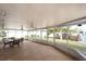 Spacious screened patio with table and chairs, overlooking the backyard at 9820 Royal Palm Dr, Bradenton, FL 34210